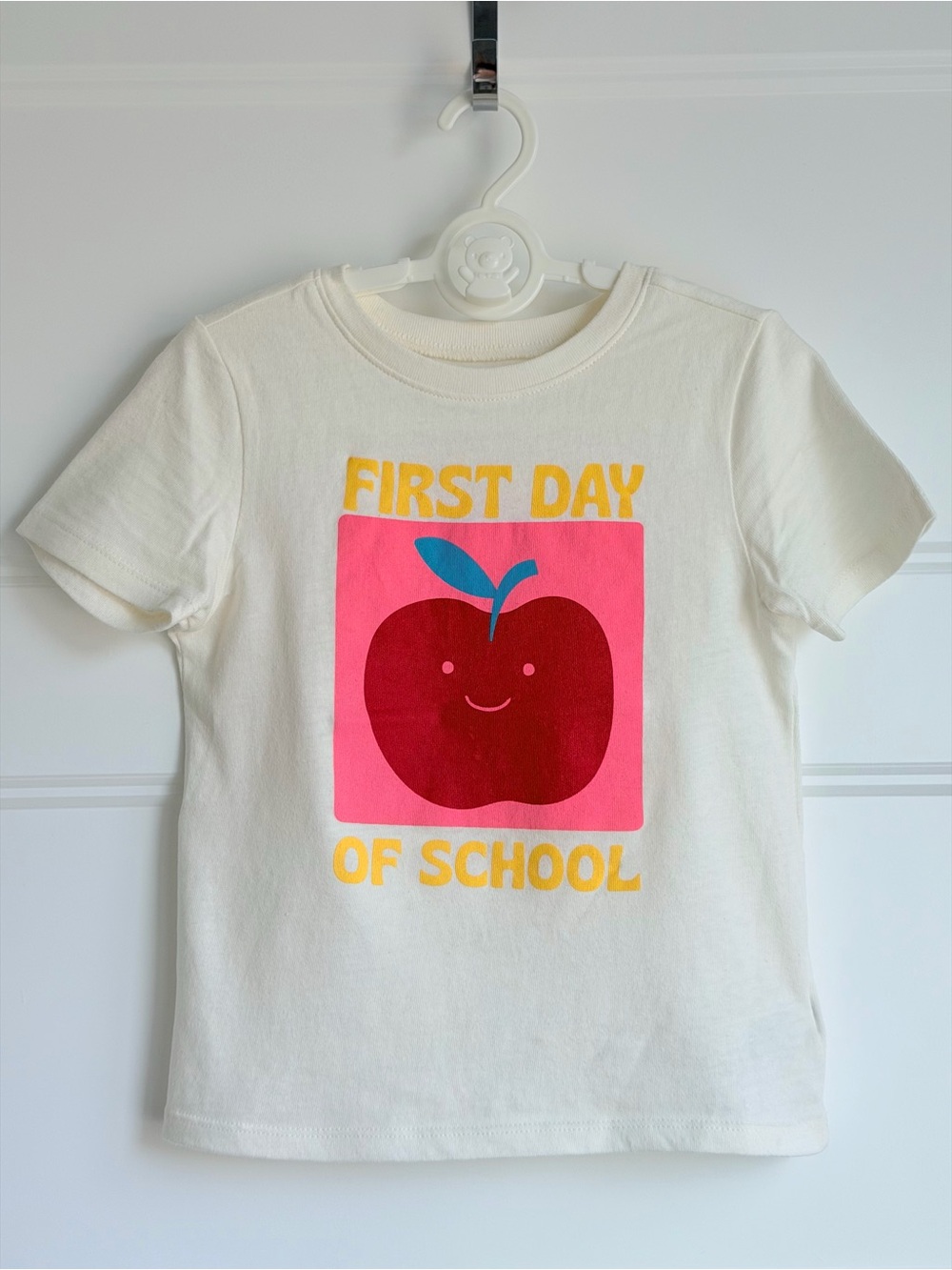 Old Navy Cream Tee with Red Apple Graphic and Yellow Text